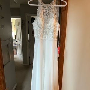 Gorgeous J.J.’s House long, white prom dress with silver accents at the top.